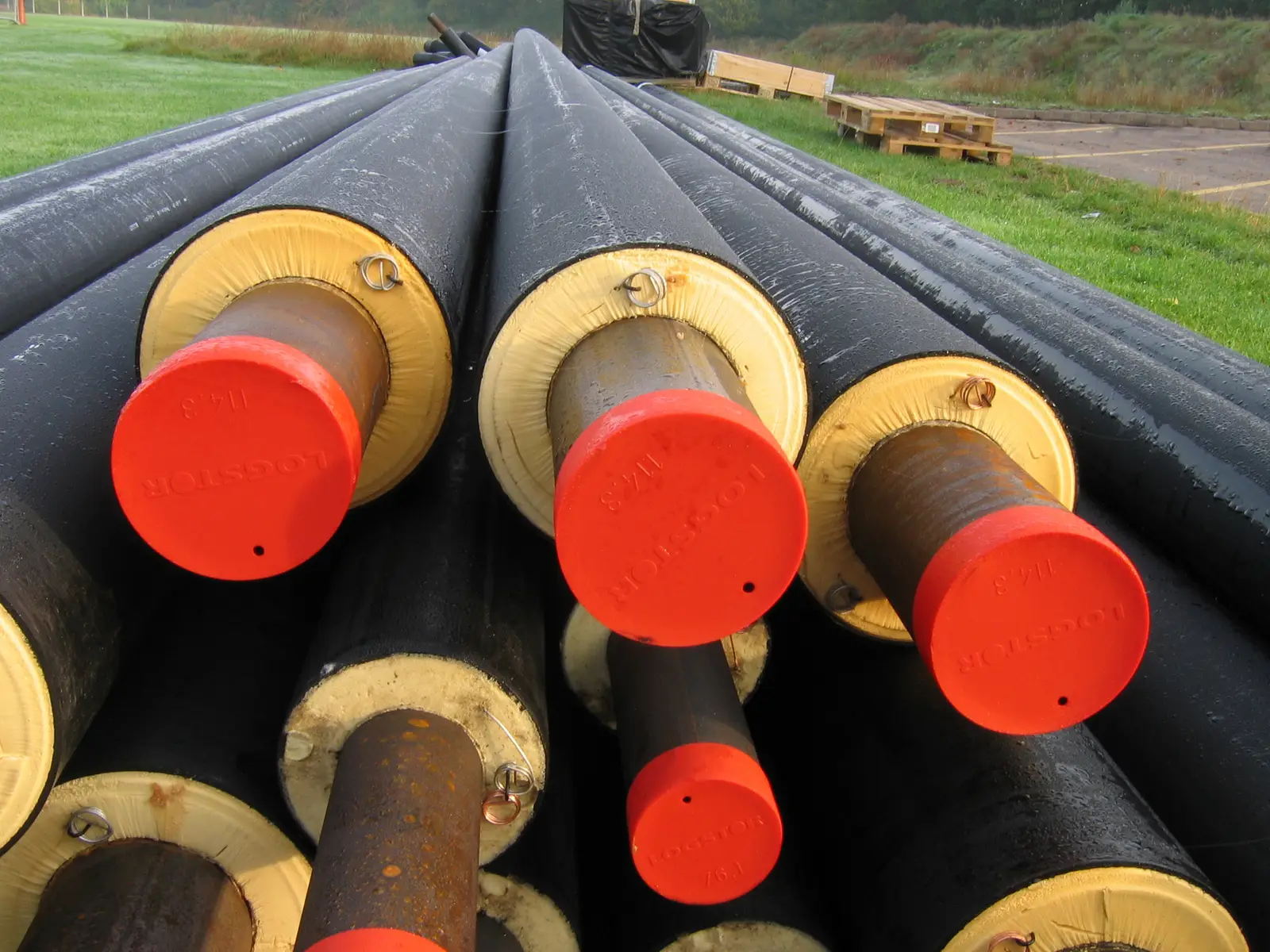Cross-section of pre-insulated bonded pipes showing steel service pipe, PU foam and PE jacket