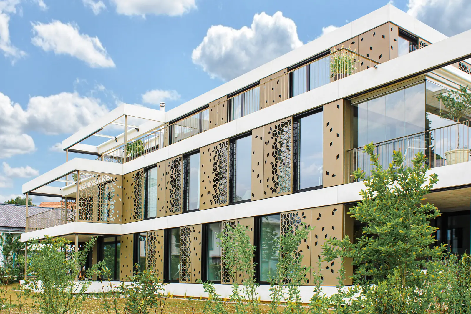 Building facade with external solar shading screens over glazed areas
